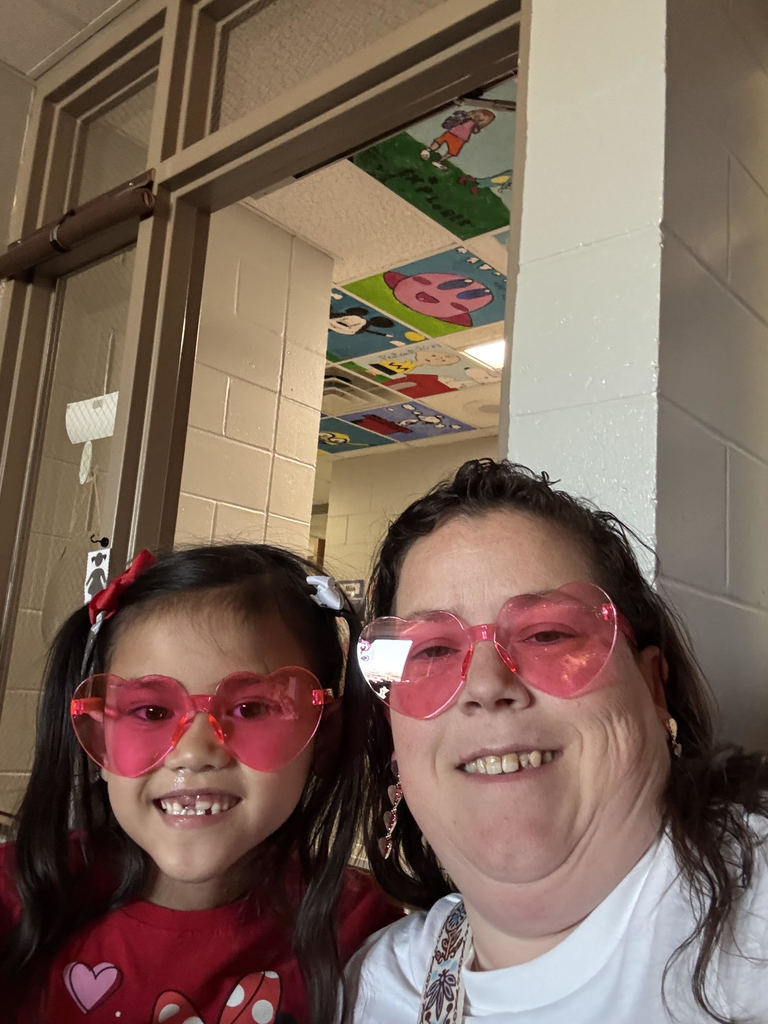 Venessa Miller with a student wearing heart glasses