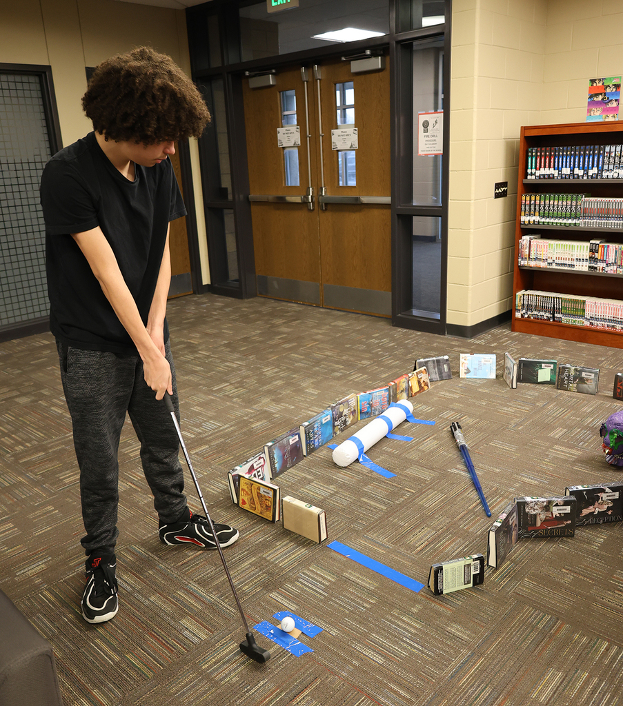 Library Mini Golf - Student working through a golf maze