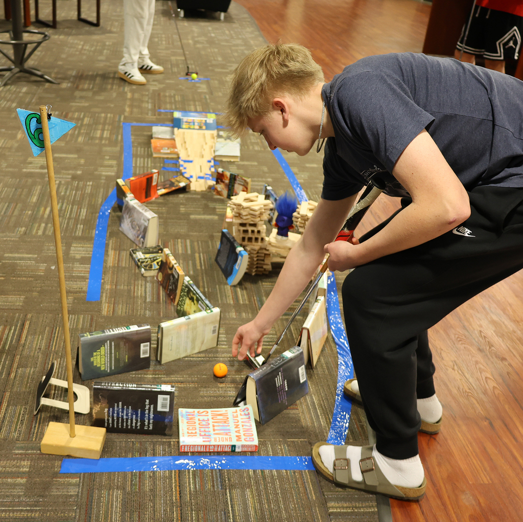 Library Mini Golf - Student working through a golf maze