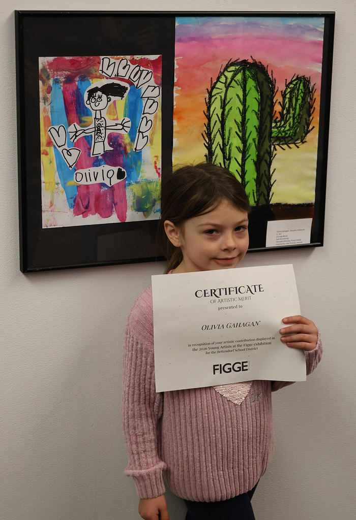 Elementary art showcase at The Figge - student posin in front of her art