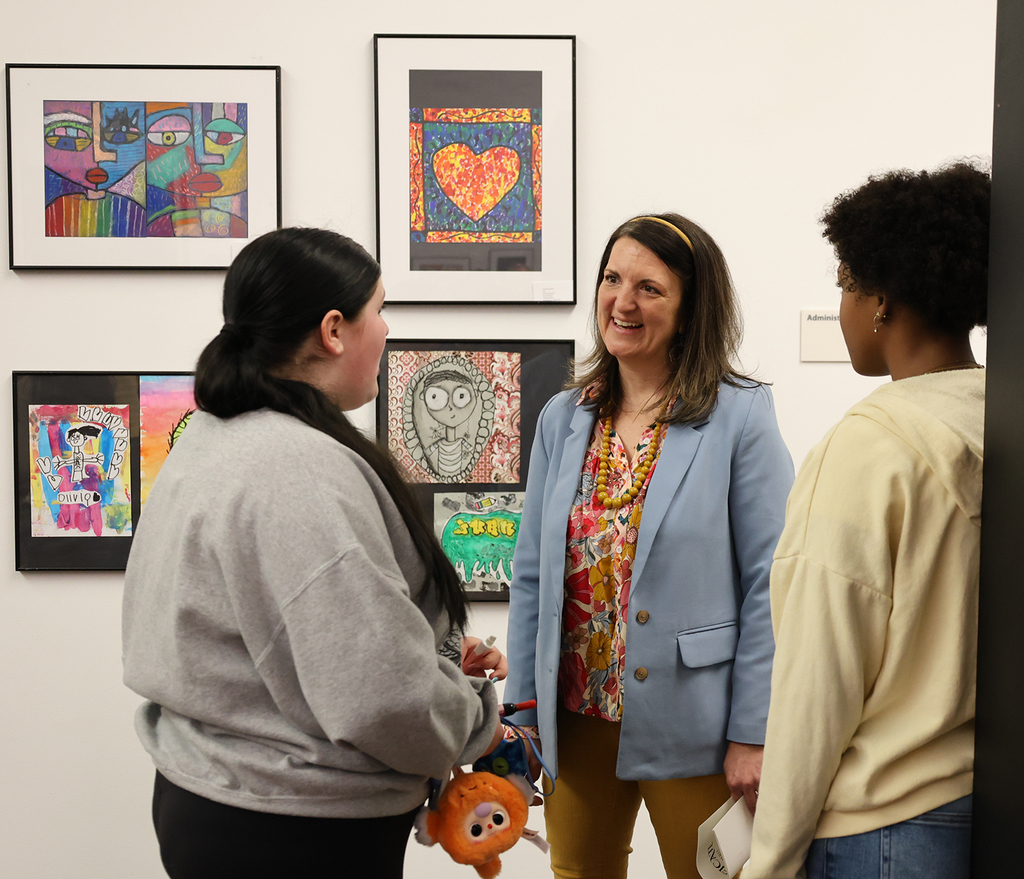 Elementary art showcase at The Figge -Mrs Purcell talking with guests