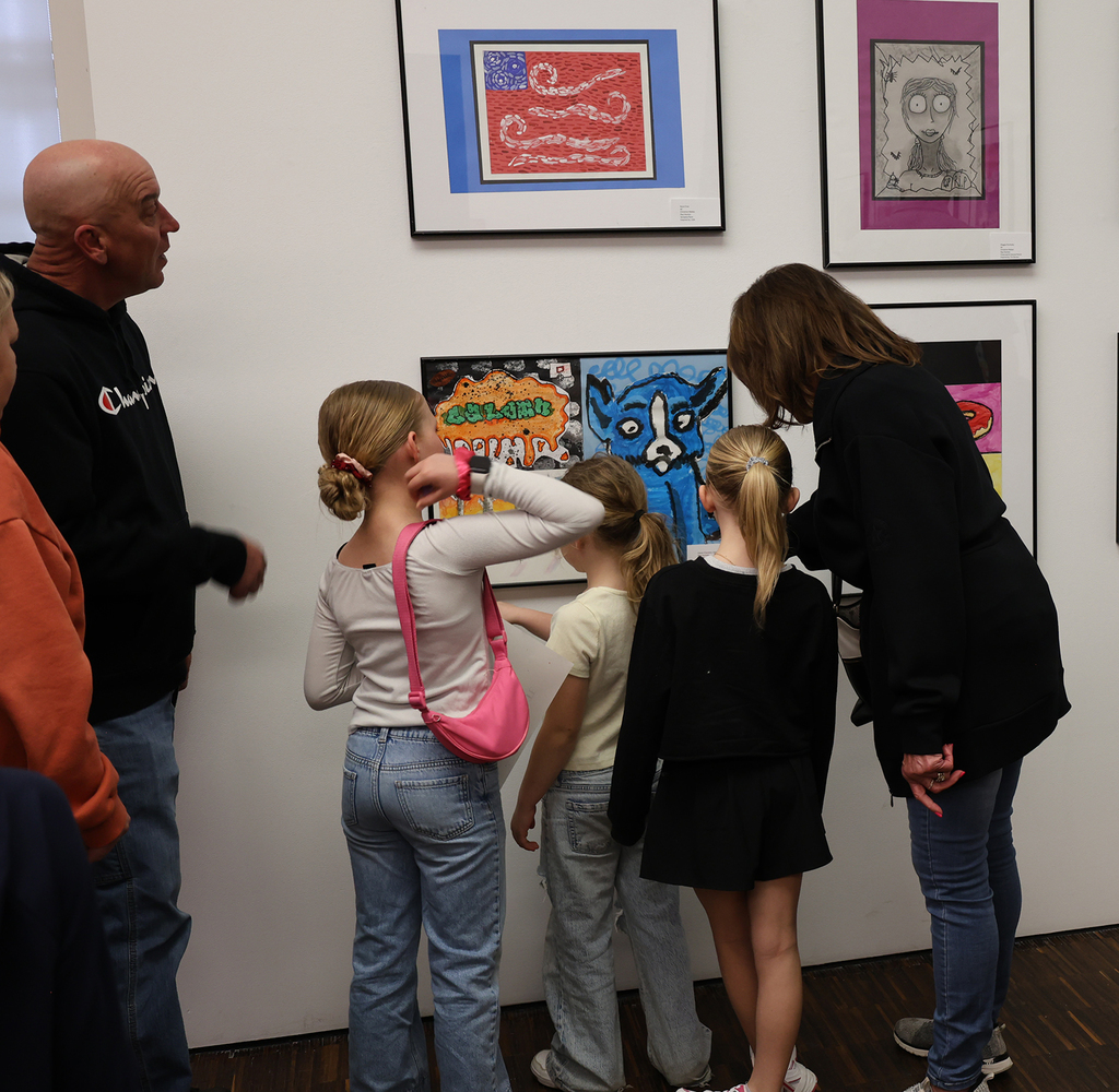 Elementary art showcase at The Figge -  a group of girl and a mom checking out a work of art