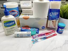 Picture of hygeine items: Clorox whites, lotion, soap, toliet paper, tooth brush and paste