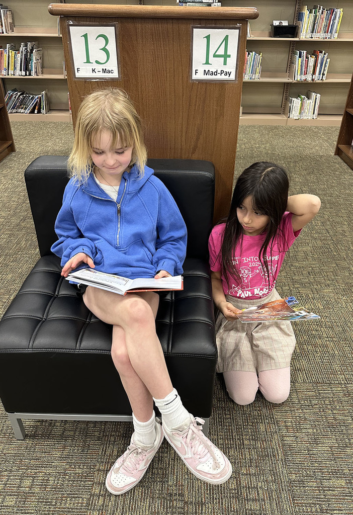Two girls reading books