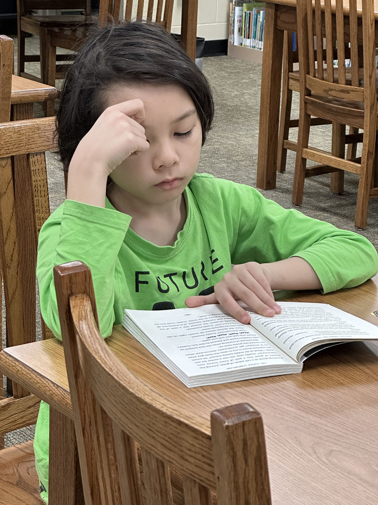Student fully absorbed in his reading