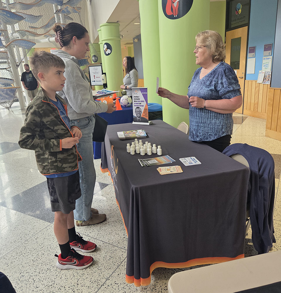 A mom and her son visiting with one of the community organizations