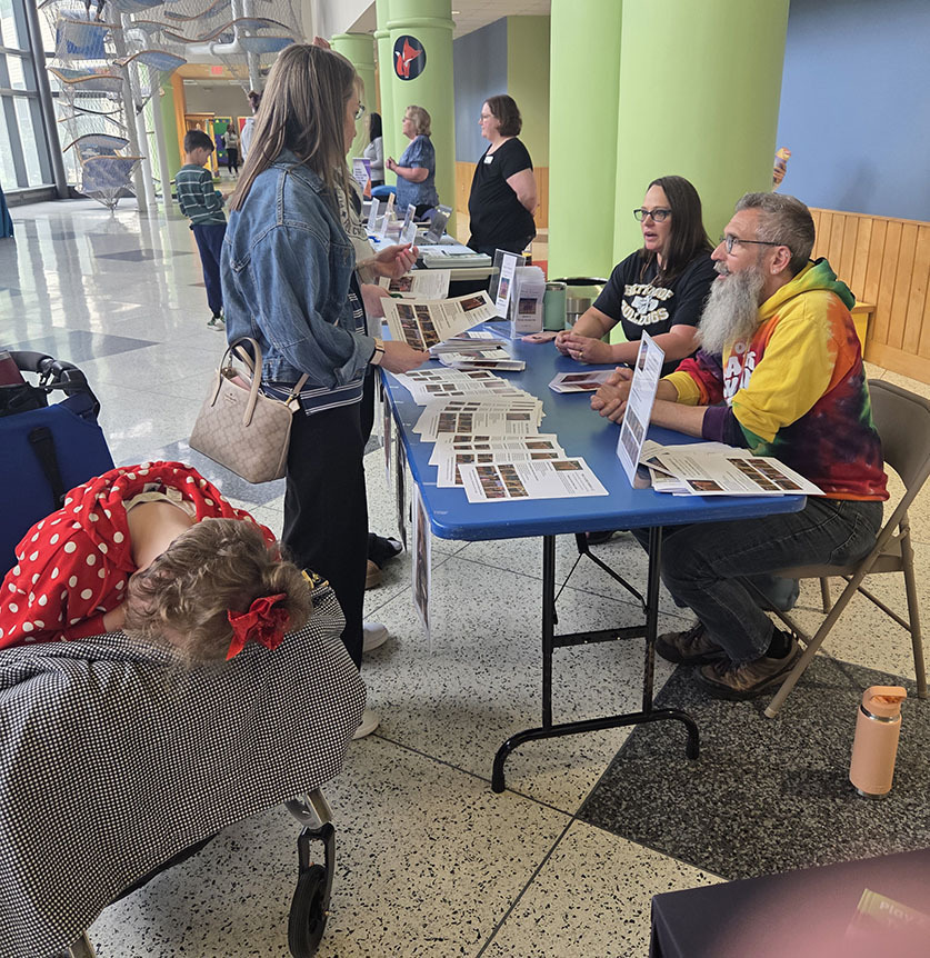 A mom visiting with one of the community organizations