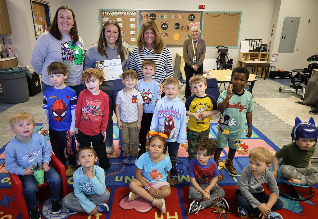 Kate Jensen with Dr. Morse, Principal Burchard, and her students