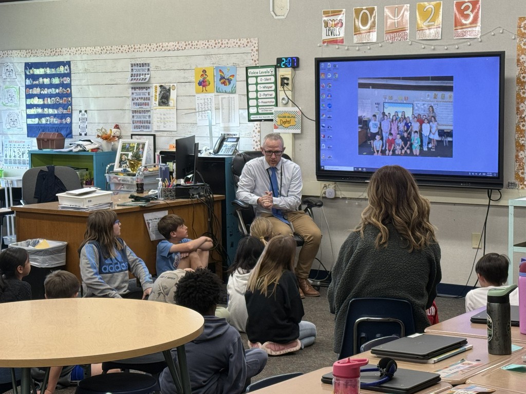 Ben Reller visites with students