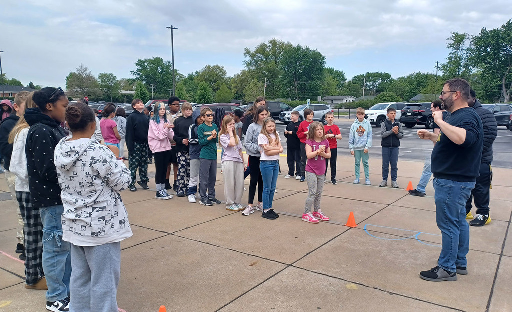 5th grade students lining up outside the school