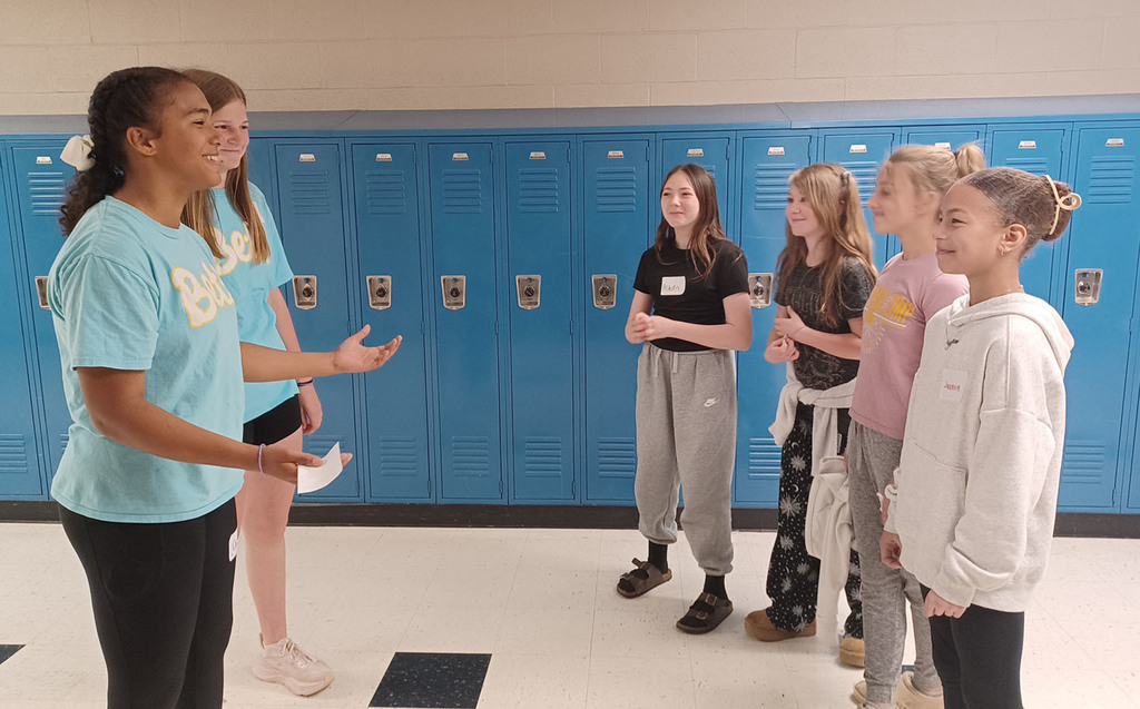 Middle school girls visiting with 5th grade girls