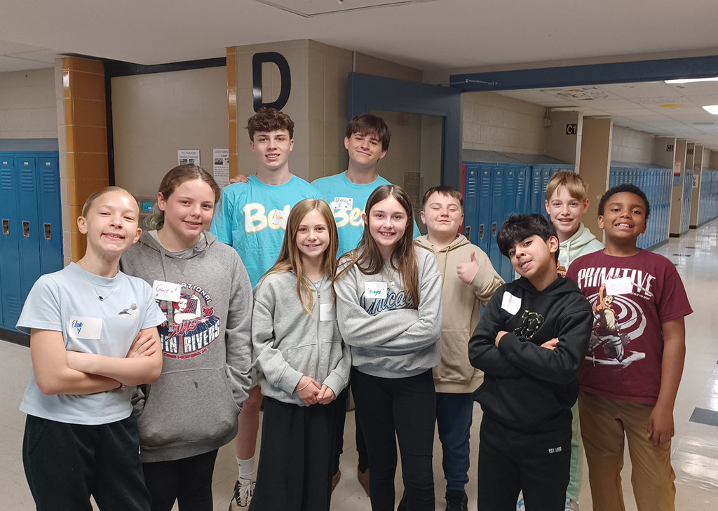 5th grade students and a couple middle school student hosts in the hallway with lockers