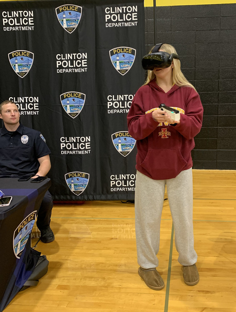 Student tryng out goggles and speed camera at the Clinton Police display