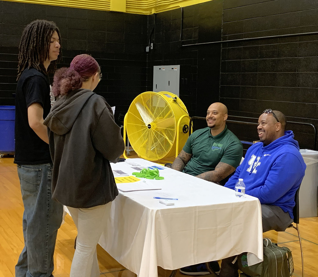 Students talking to staff one of the displays