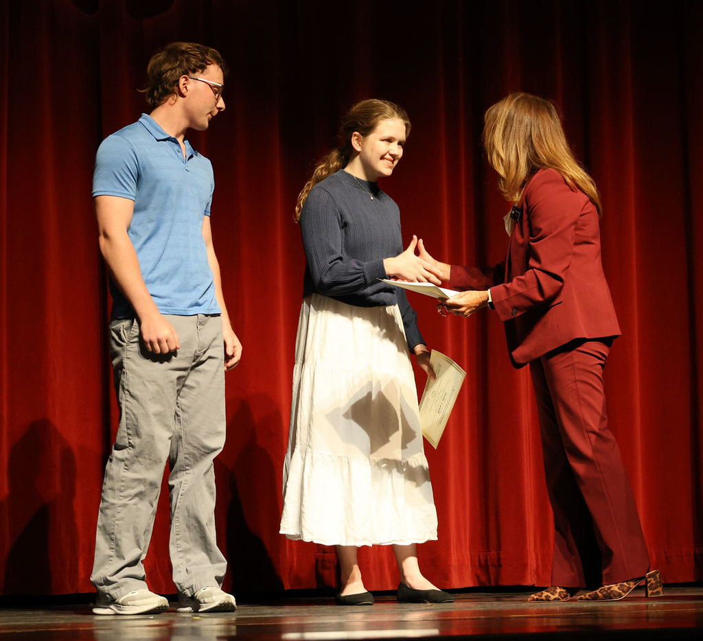 Dr. Michelle Morse awarding the Bettendorf Rotary Scholarship to Jonathan Isaacson and Stella Lundh