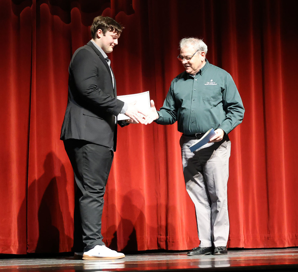 Robert De Lacy awarding the DeLacy Family Foundation scholarship to Owen Schertz