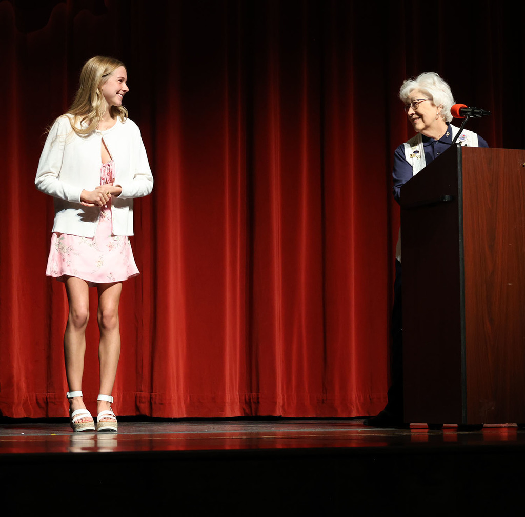 Pat Larson from the Lions Club awarding a scholarship to Marlee Behrends 