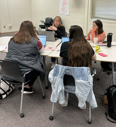 Teachers having a conversation at a table