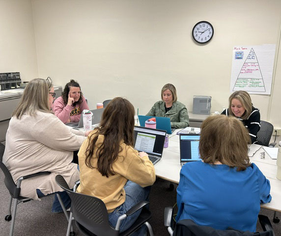 Teachers having a conversation at a table