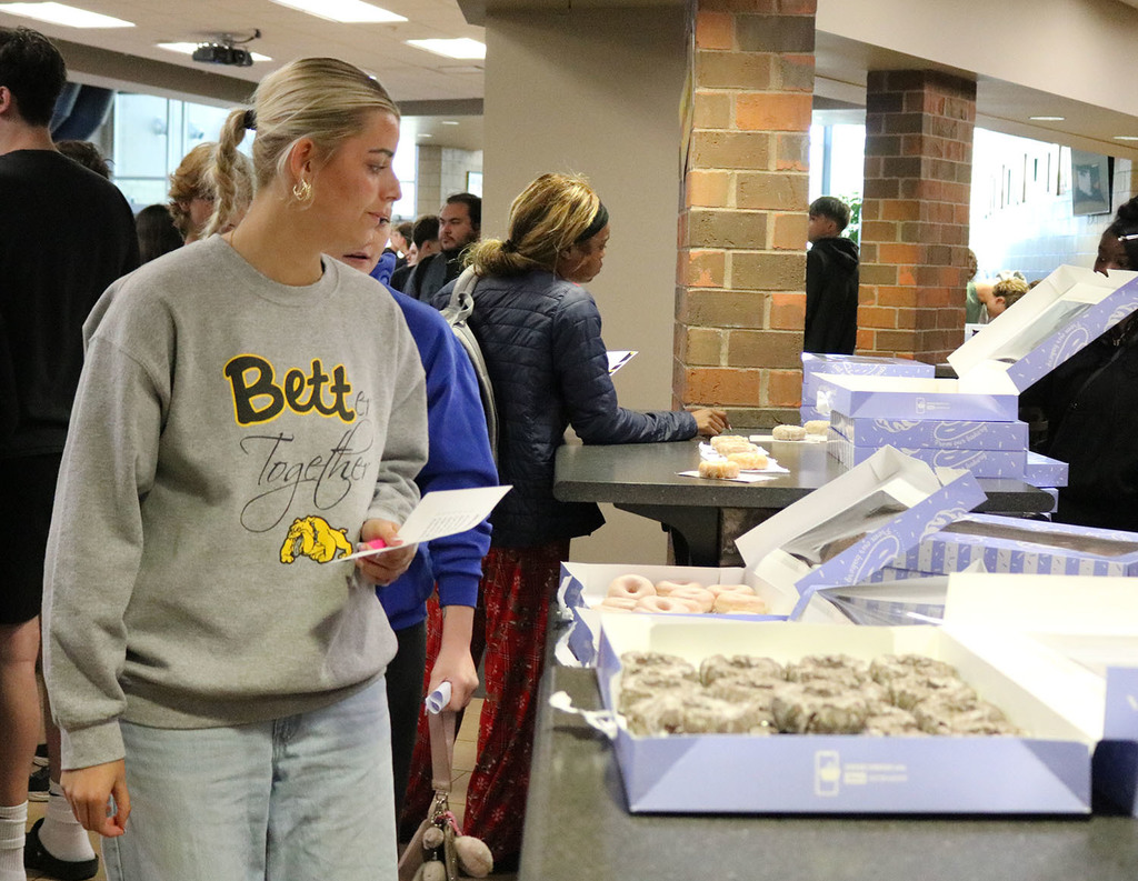 A girl checking out the donut options