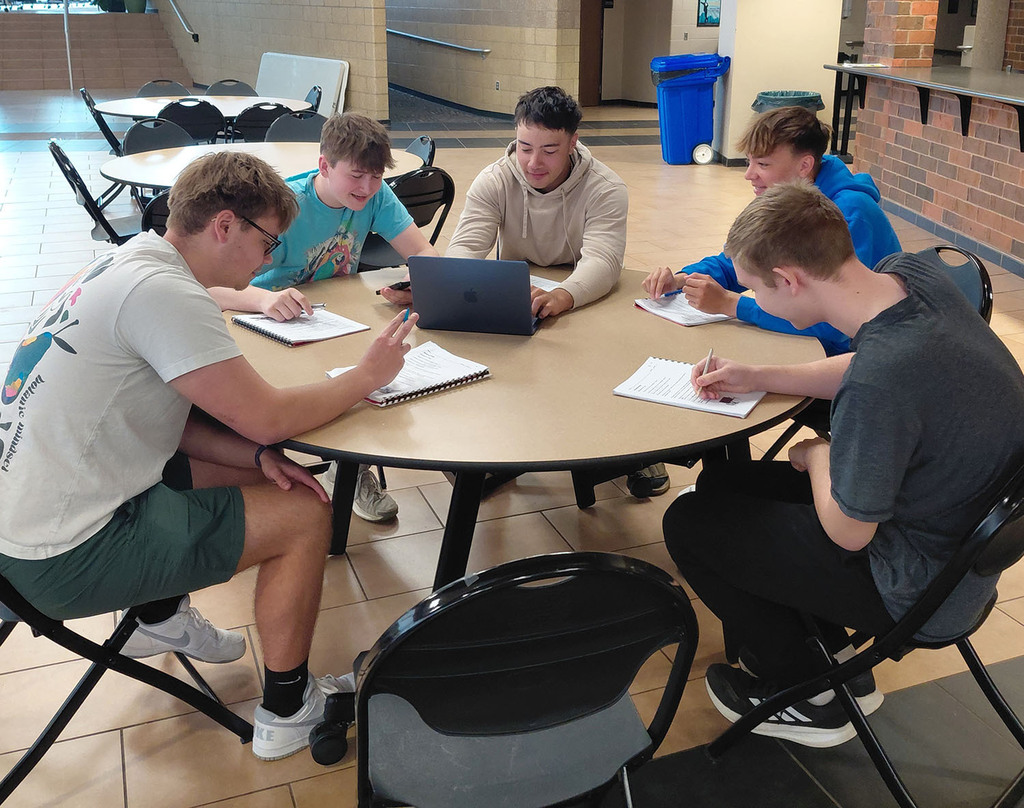 Table of boys calling a grandparent and taking notes
