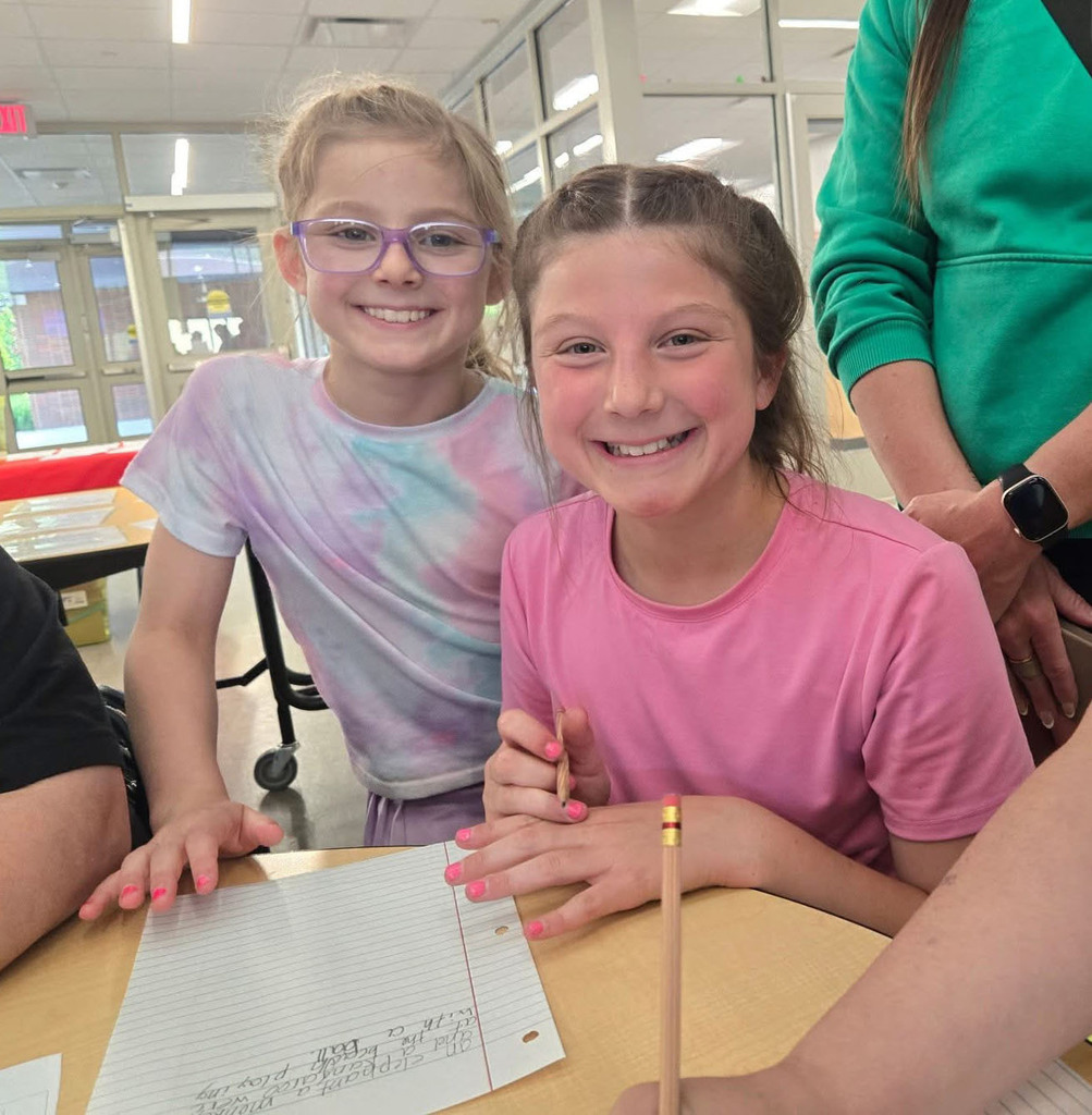 Two girls with something they've written