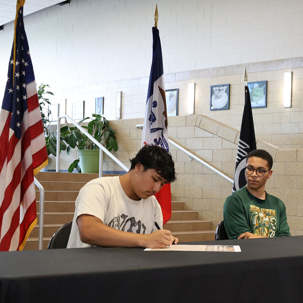 Christian Ragan signing with Tavian Willingham looking on