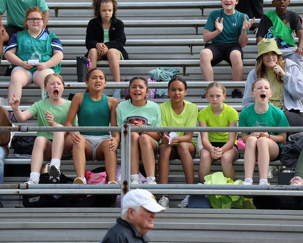Girls cheering on the green team