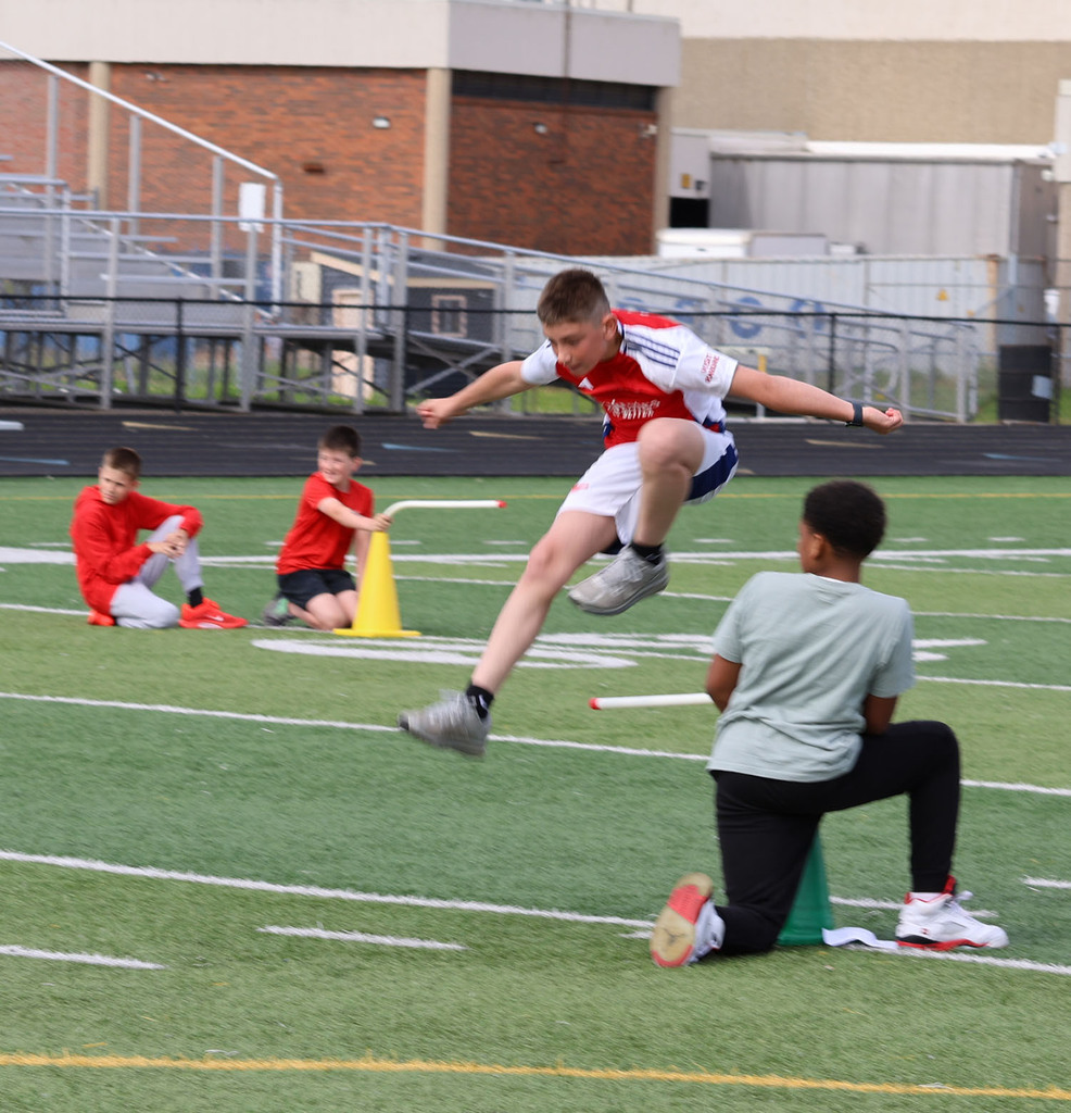 Boy jumping a hurdle