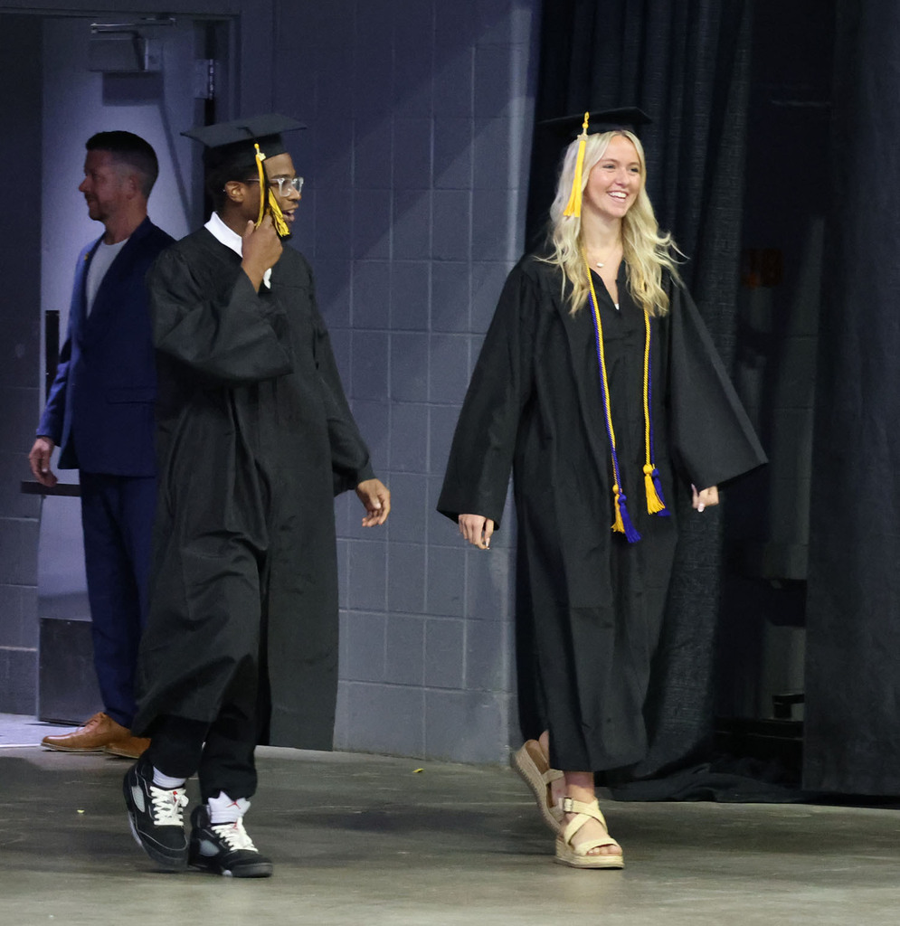 Students walking onto the arena floor
