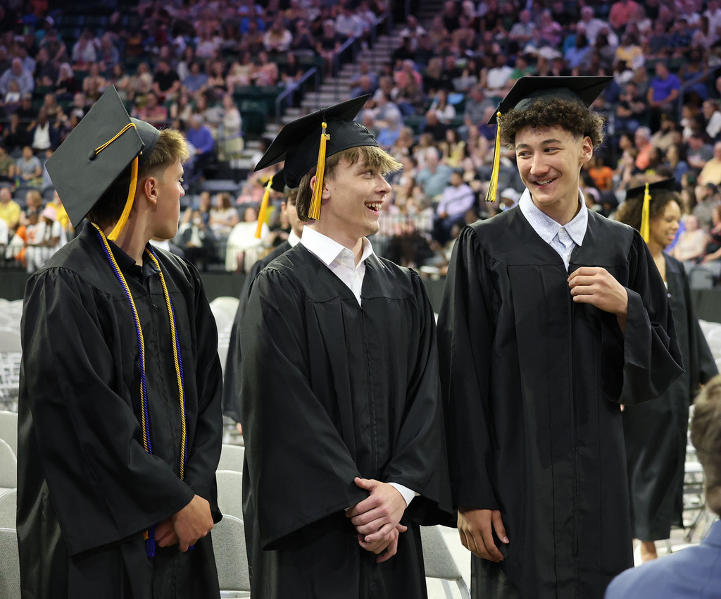 Two boys smiling at their seats
