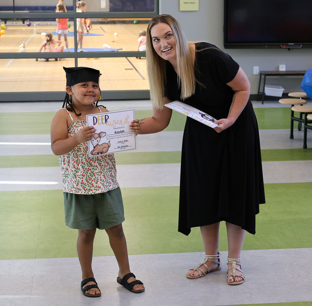 Student  smiling at her family with Miss Amanda