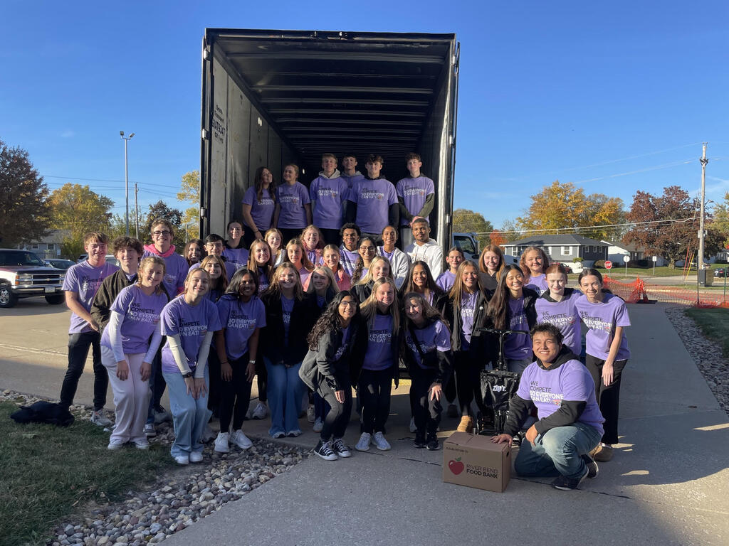 Student Council pose for a pic after loading the semi trailer with food drive donations.