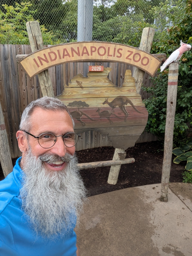 Mr Ron with the zoo sign in frame.