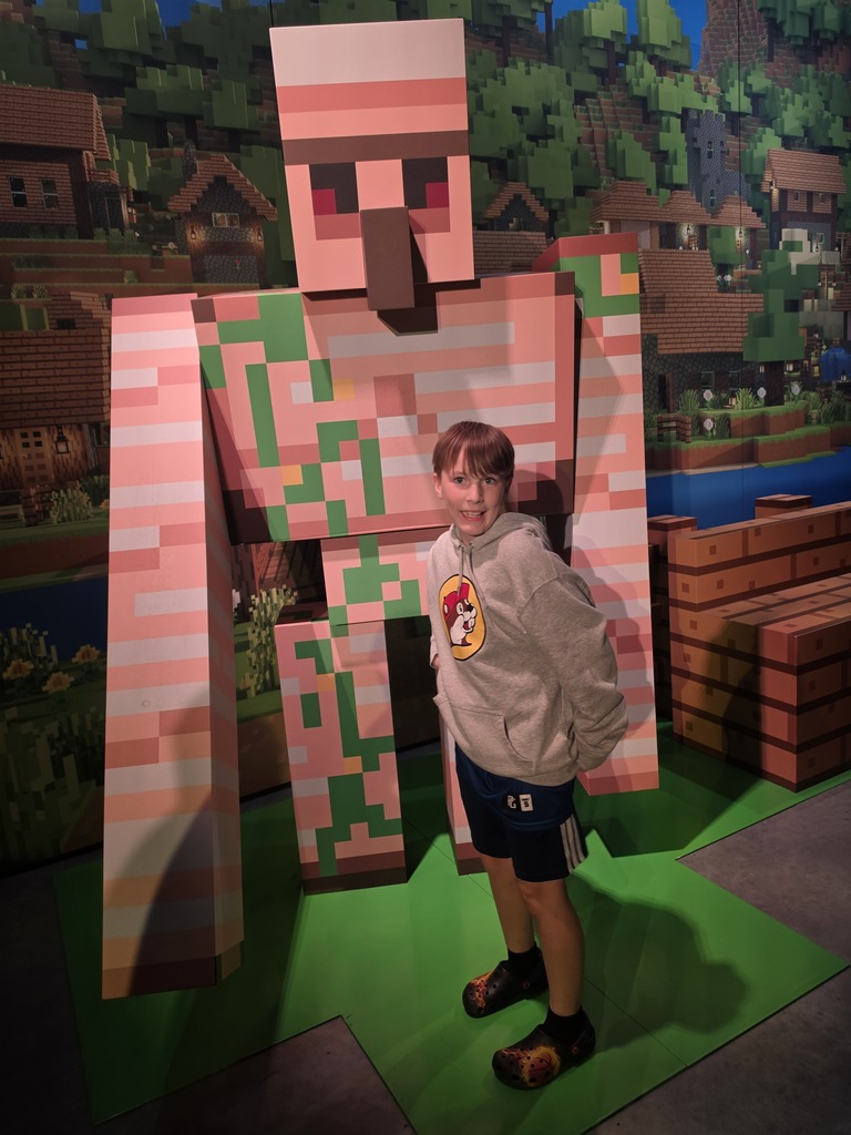 Andrew in front of a Minecraft man.