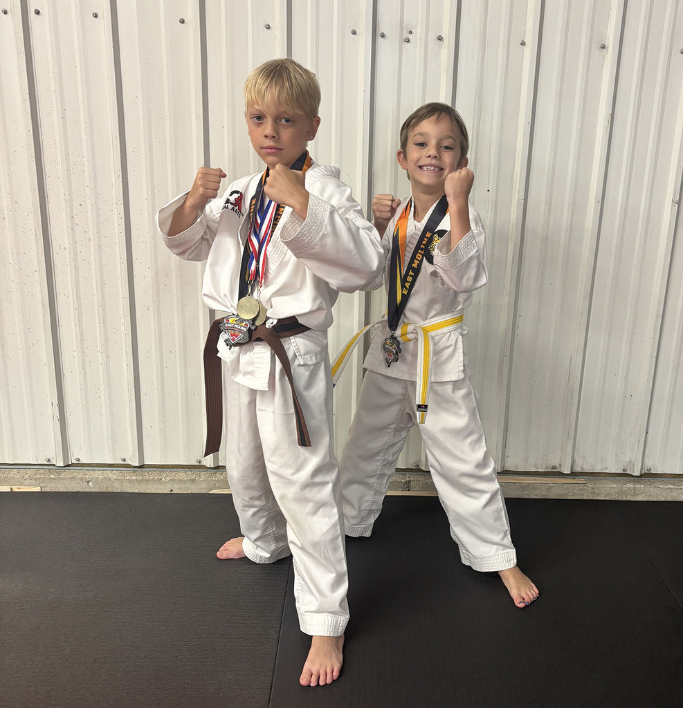 Simon and Tyson Severson with medals from their taekwondo tournament.