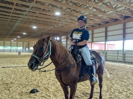 Abigail on a horse in a building