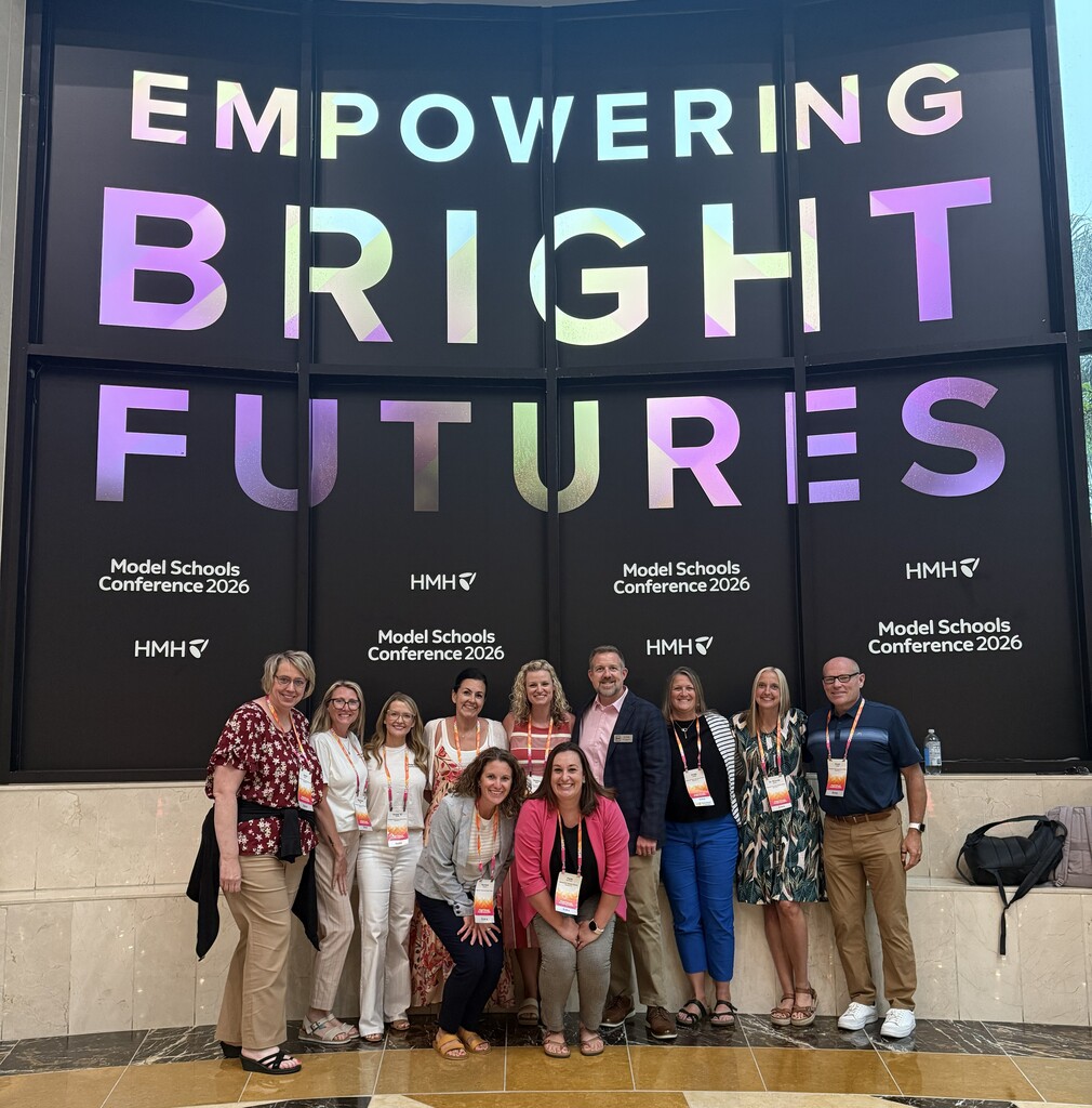 BCSD Administrators in front of the "Empowering Bright Futures" display