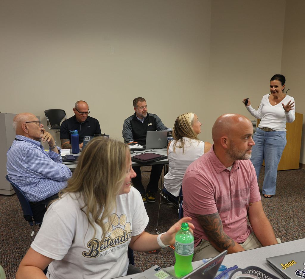 District administrators smiling as they learn