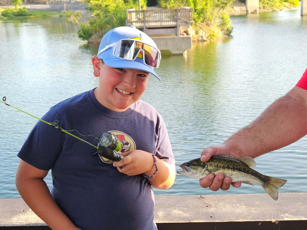 Nolan with a fishing pole and a fish