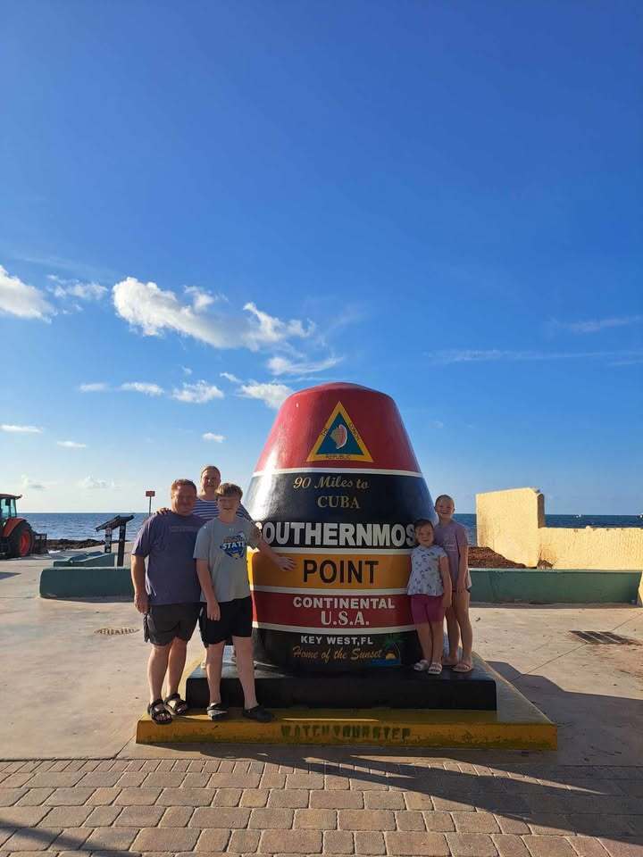 The Mueller family by a giant buoy marking the southernmost point in the continental U.S.A