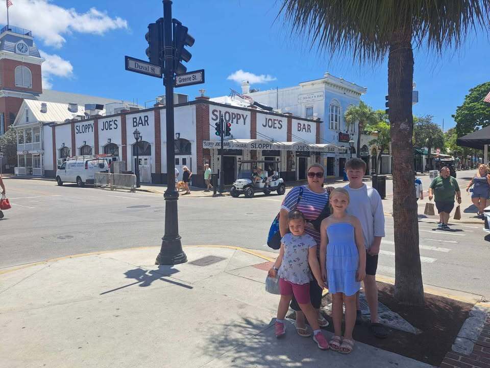 Mrs Mueller and her kids with Sloppy Joe's Bar in the background