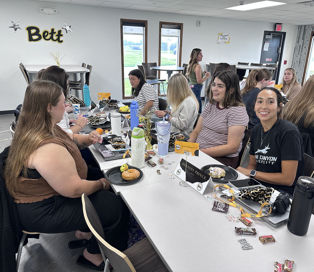 New teachers visiting with each other at their table
