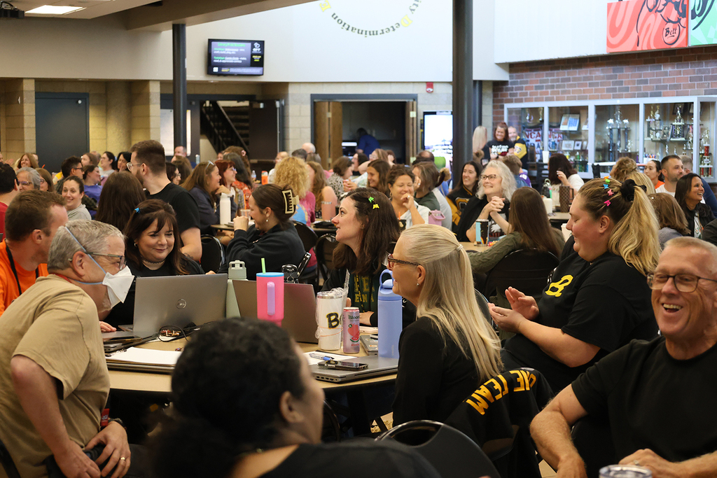 Staff having fun as hear AI music and lyrics representing each decade staff attended high school.