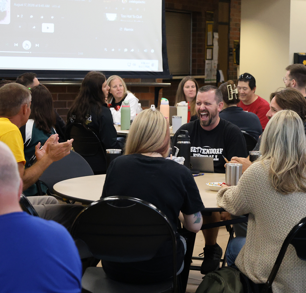 Staff having fun as hear AI music and lyrics representing each decade staff attended high school.