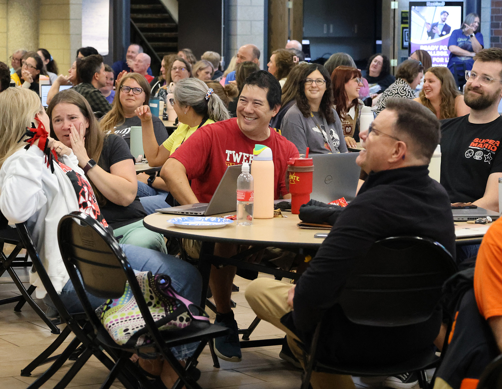 Staff having fun as hear AI music and lyrics representing each decade staff attended high school.