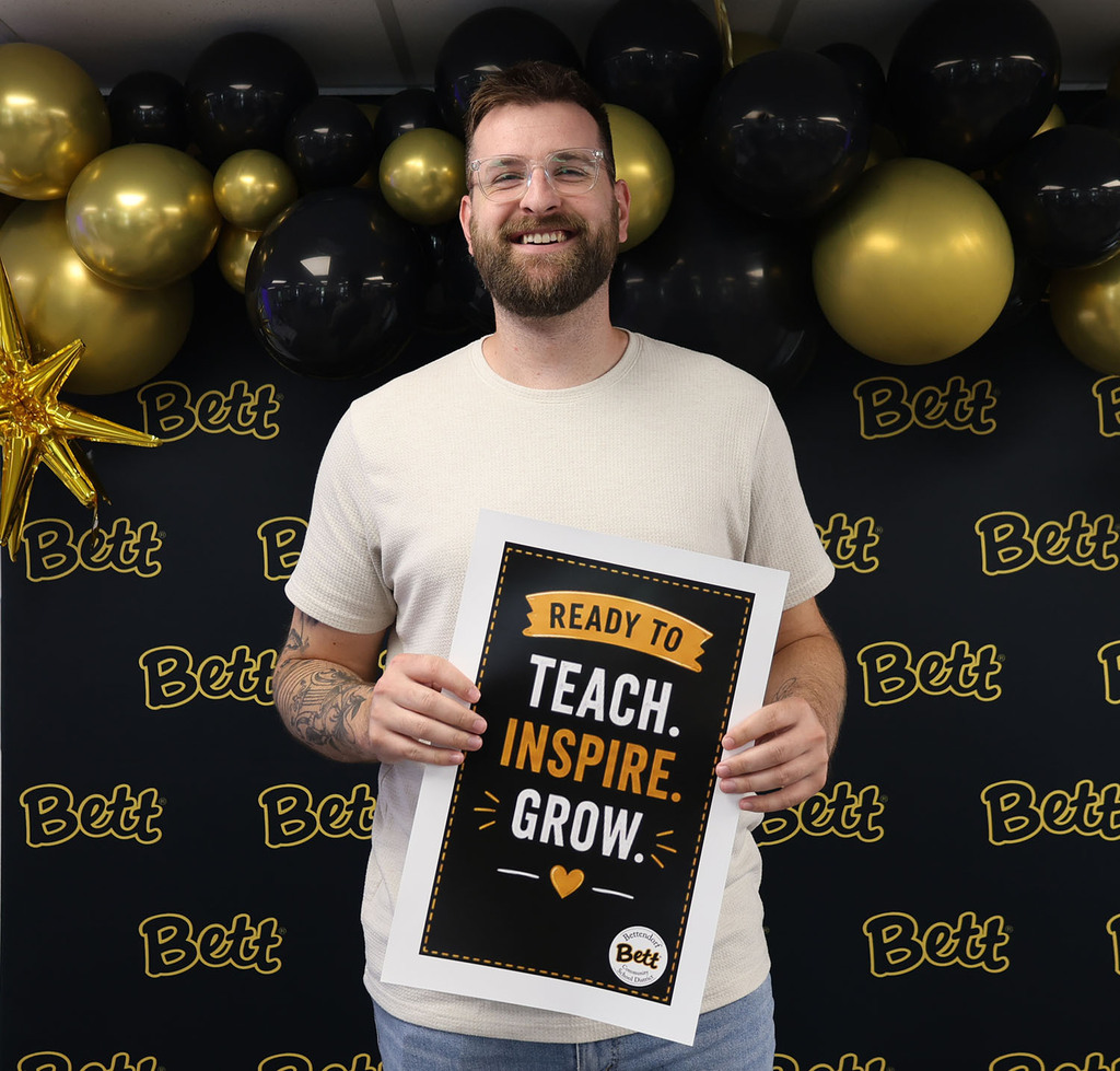 Tyler DeMaree - BHS - holding a sign: Ready to teach. Inspire. Grow. Heart. Bettendorf Community School District logo with Bett graphic.