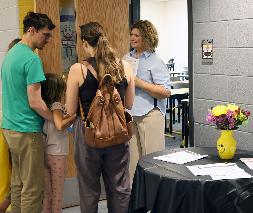 Beth Laubaum visiting with a family