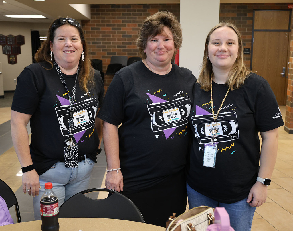 Paul norton staff showing of their school spirit shirts - Paul Norton is Bringing it Back!