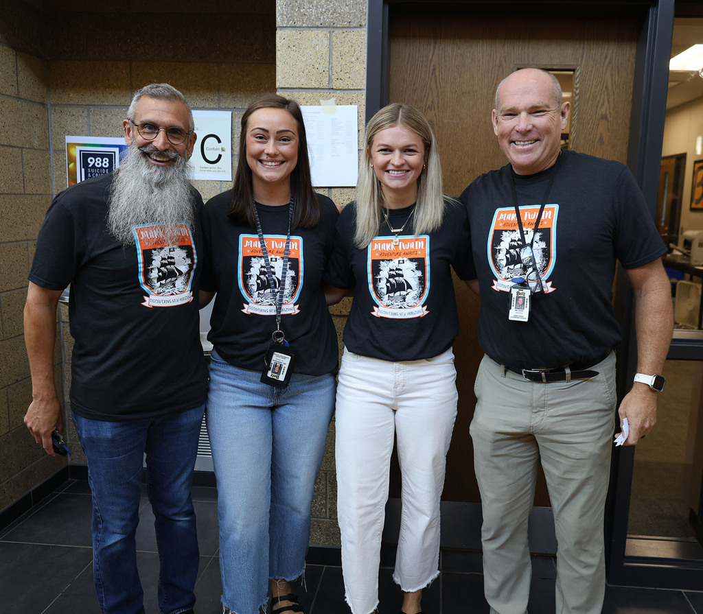 Mark Twain staff post for a picture with a picture of a sail boat and discovering new horizons